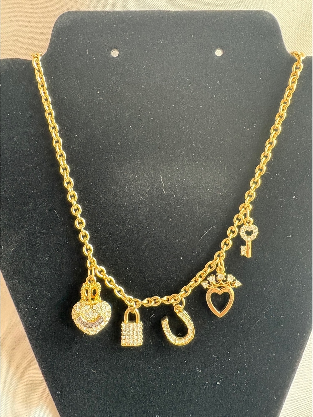 Gold Tone Charm Necklace with Heart, Key, Lock, and Horseshoe Pendants